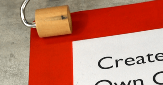 Using a Heskins Seam Roller to Flatten Custom Signage for Proper Adhesion