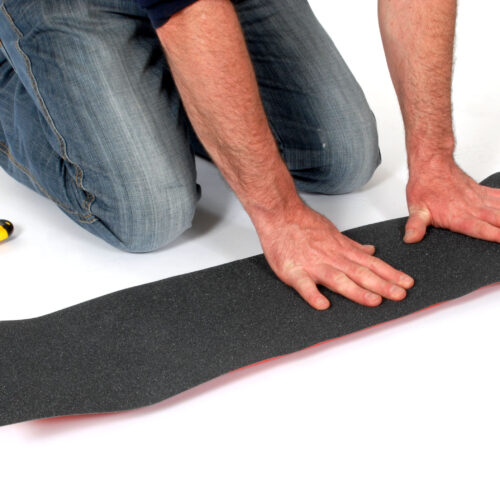 H3422-Skateboard-Grip-Tape-Aerated-Carbide-Being-Applied-to-Skateboard-4.jpg