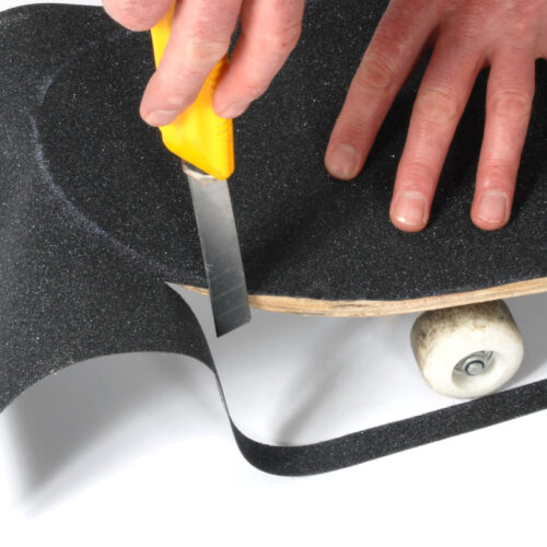 H3422-Skateboard-Grip-Tape-Aerated-Carbide-Being-Cut-to-Fit-Skateboard-1.jpg